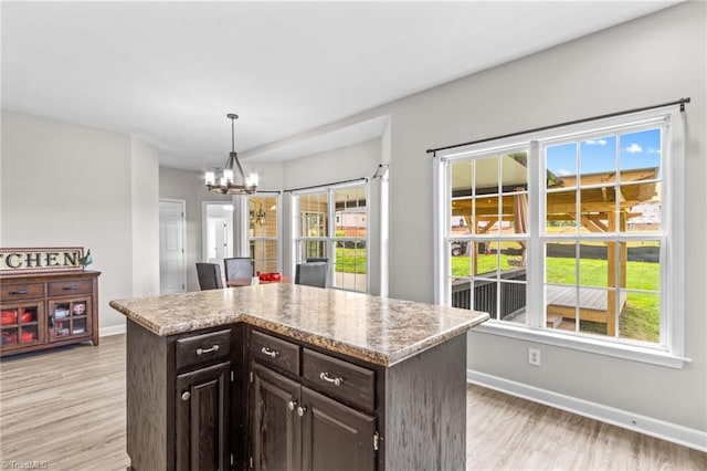 159 Forest Abbey Ln, China Grove, NC 28023 - kitchen with light wood-style flooring, a chandelier, a center island, and decorative light fixtures