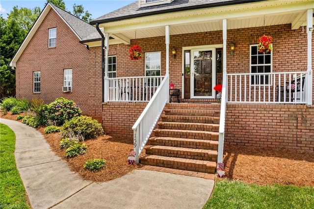 159 Forest Abbey Ln, China Grove, NC 28023 - property entrance with covered porch, brick siding, and roof with shingles
