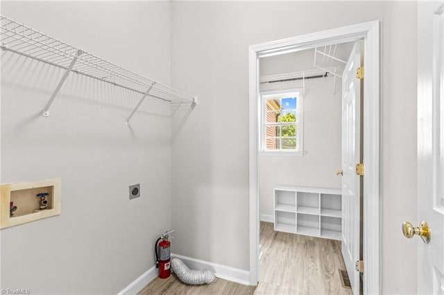 159 Forest Abbey Ln, China Grove, NC 28023 - laundry room featuring electric dryer hookup, washer hookup, and wood finished floors