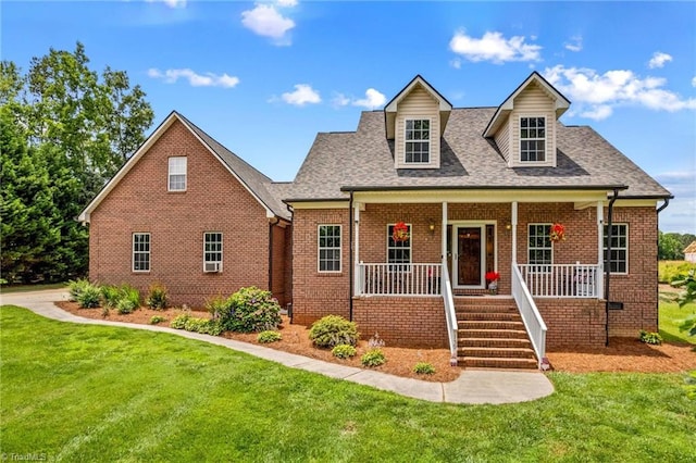 159 Forest Abbey Ln, China Grove, NC 28023 - new england style home with brick siding, covered porch, and a front lawn