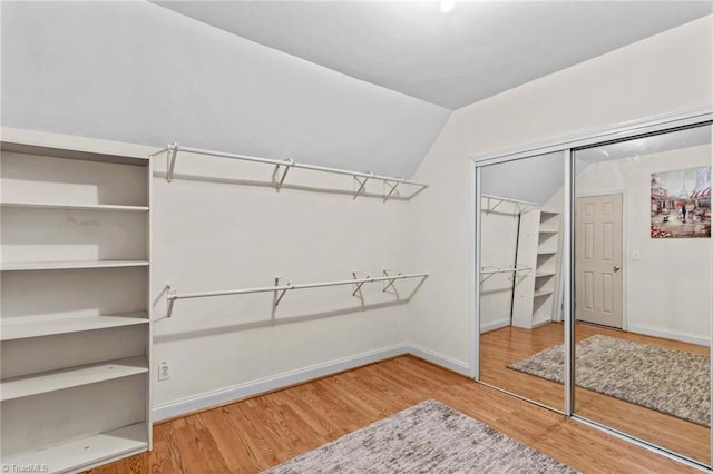 159 Forest Abbey Ln, China Grove, NC 28023 - spacious closet with vaulted ceiling and wood finished floors