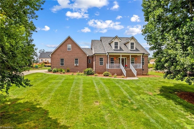159 Forest Abbey Ln, China Grove, NC 28023 - cape cod-style house with covered porch, a front yard, and brick siding