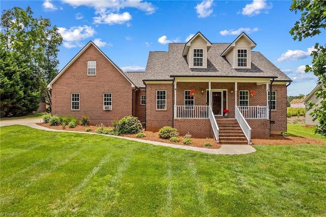 159 Forest Abbey Ln, China Grove, NC 28023 - new england style home featuring brick siding, a porch, a front yard, stairway, and roof with shingles