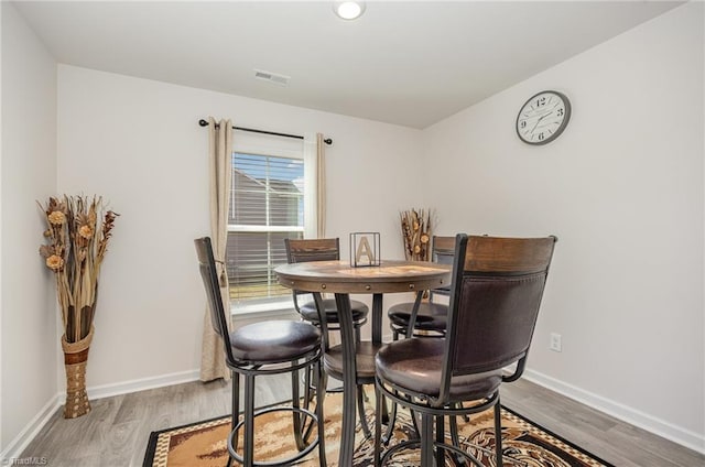 dining space with hardwood / wood-style floors