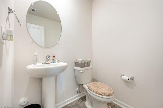 417 Daniel Dr, Lexington, NC 27295 - bathroom featuring toilet, baseboards, and wood finished floors