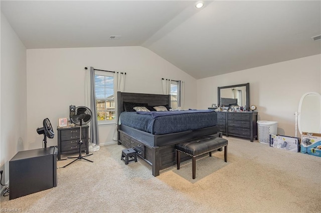 carpeted bedroom with lofted ceiling