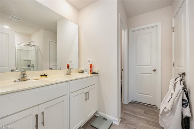 417 Daniel Dr, Lexington, NC 27295 - bathroom with a stall shower, wood finished floors, double vanity, and baseboards