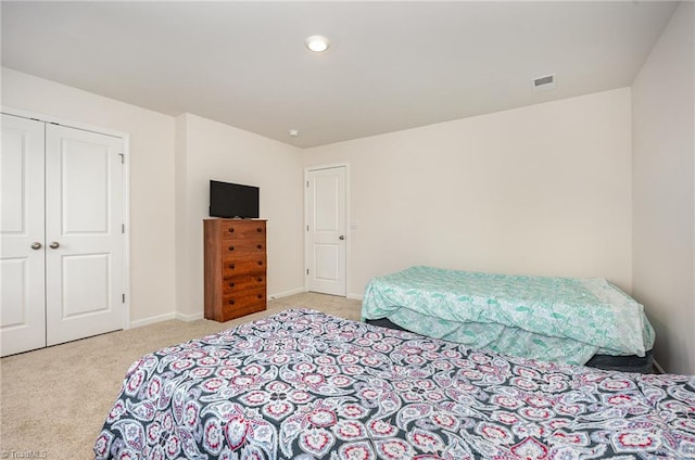 carpeted bedroom with a closet