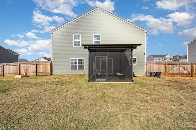 rear view of house featuring a yard and a sunroom