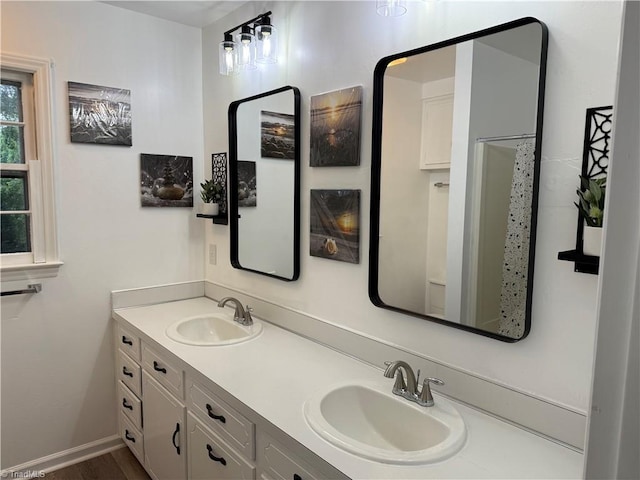 1427 Westwood Ln, Wilkesboro, NC 28697 - bathroom featuring double vanity, curtained shower, and wood finished floors