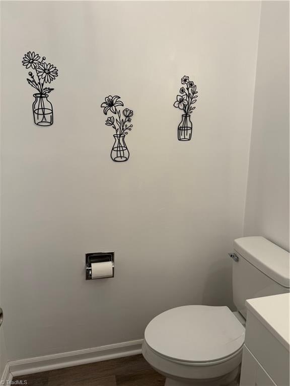 1427 Westwood Ln, Wilkesboro, NC 28697 - bathroom featuring toilet, vanity, wood finished floors, and baseboards
