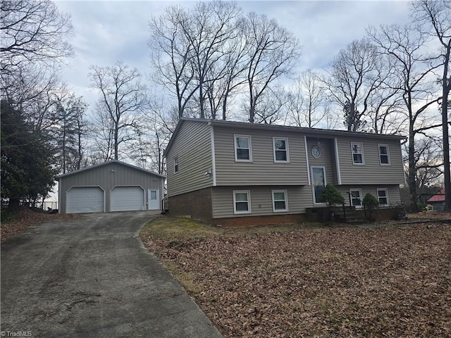 bi-level home with a garage and an outbuilding