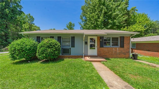 157 Blaze St, Winston-Salem, NC 27105 - view of front facade with a front yard and brick siding