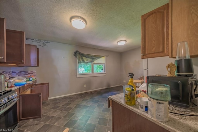 157 Blaze St, Winston-Salem, NC 27105 - kitchen with stainless steel electric range oven, a textured ceiling, tasteful backsplash, and brown cabinetry