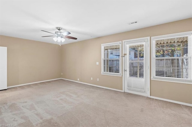 carpeted spare room with ceiling fan