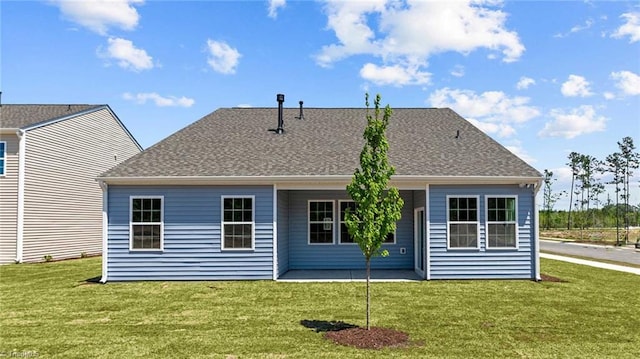 rear view of house featuring a lawn