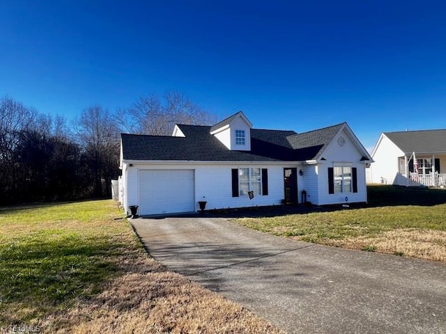 view of front of house with a garage and a front lawn