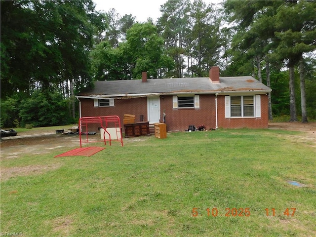 314 S Mccallum St, Candor, NC 27229 - view of front of property with a chimney, a front lawn, and brick siding
