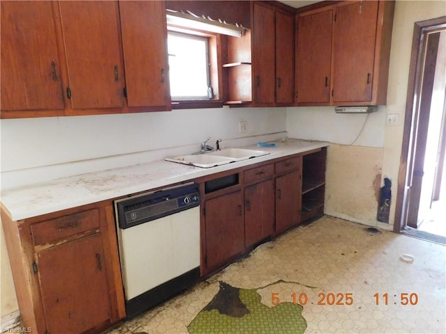 314 S Mccallum St, Candor, NC 27229 - kitchen featuring white dishwasher, a sink, light flooring, light countertops, and brown cabinetry
