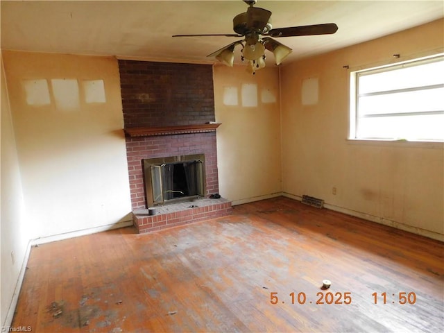 314 S Mccallum St, Candor, NC 27229 - unfurnished living room featuring wood finished floors, a ceiling fan, a brick fireplace, and baseboards