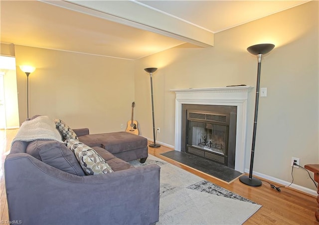 living room featuring wood-type flooring and beamed ceiling