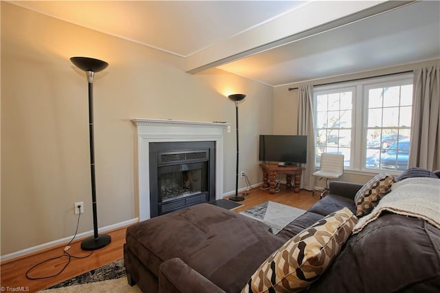 living room featuring light hardwood / wood-style floors and beamed ceiling