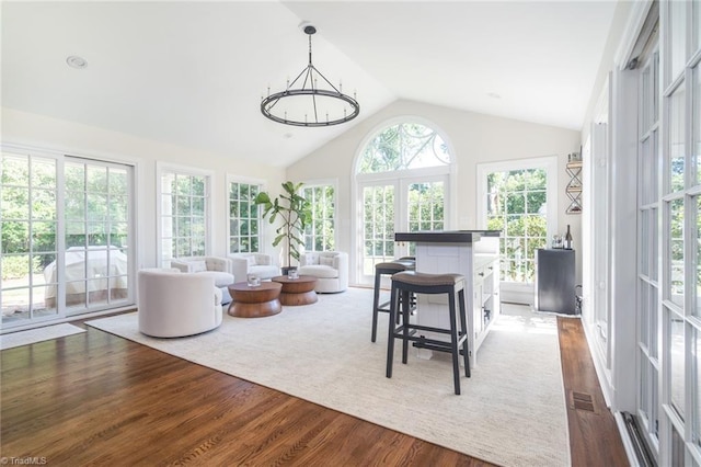 sunroom / solarium with an inviting chandelier and vaulted ceiling