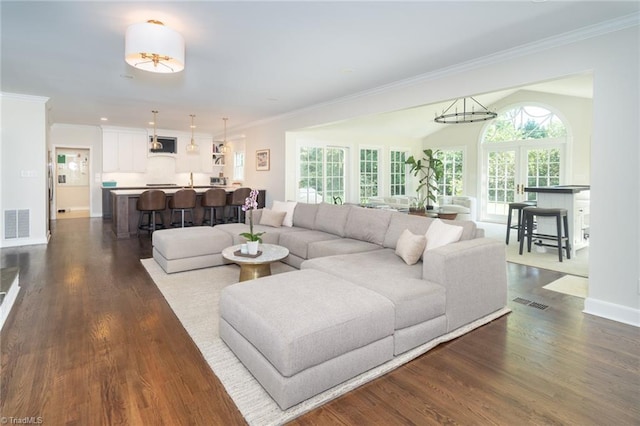 living room featuring dark hardwood / wood-style flooring and ornamental molding