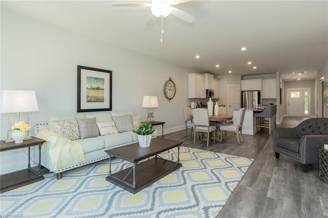 living area with recessed lighting, ceiling fan, baseboards, and wood finished floors