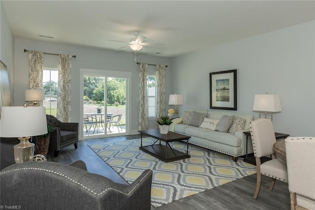 living room with visible vents, ceiling fan, and wood finished floors