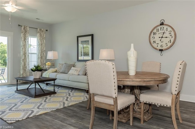 dining room featuring ceiling fan, baseboards, and wood finished floors