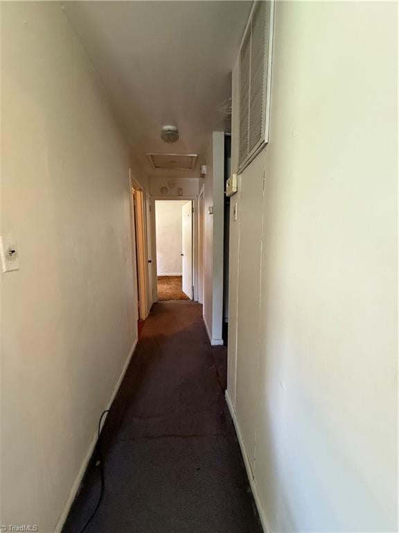 1611 Willow Rd, Greensboro, NC 27401 - hallway featuring baseboards and dark colored carpet