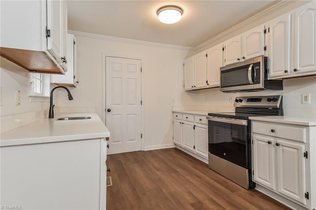 kitchen featuring dark hardwood / wood-style flooring, sink, white cabinets, and appliances with stainless steel finishes