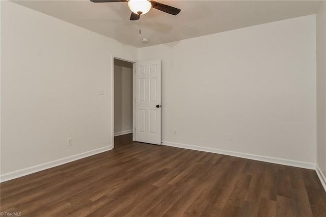 spare room with ceiling fan and dark hardwood / wood-style floors