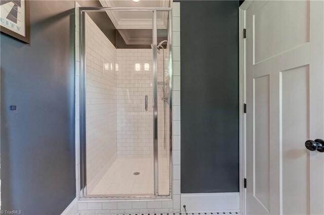 full bath featuring a stall shower and ornamental molding