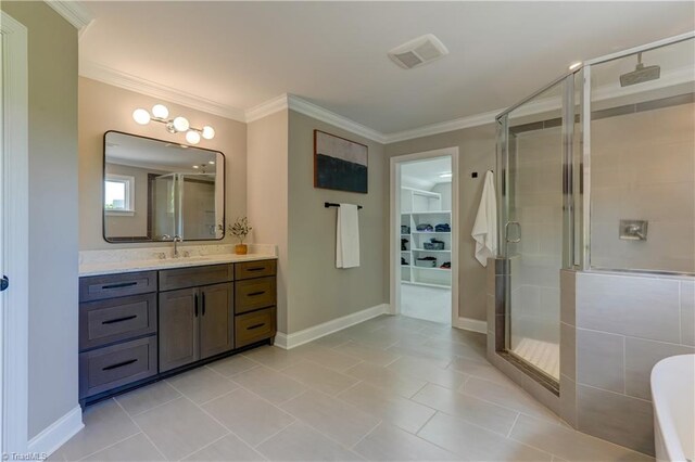bathroom featuring a stall shower, vanity, ornamental molding, baseboards, and a spacious closet