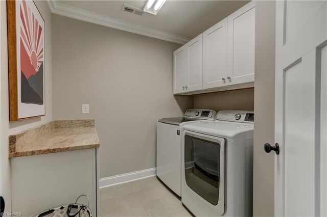 clothes washing area featuring cabinet space, separate washer and dryer, crown molding, and baseboards