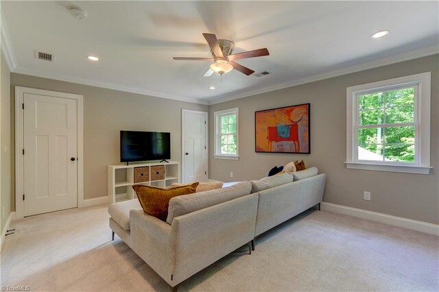 living area with light colored carpet, ceiling fan, crown molding, baseboards, and recessed lighting
