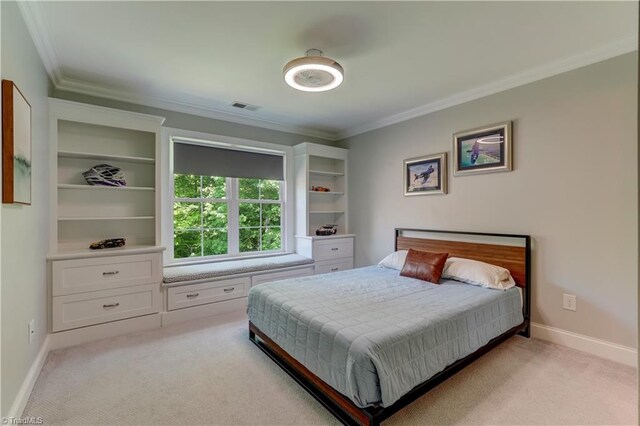 bedroom featuring ornamental molding, light carpet, and baseboards