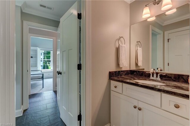bathroom featuring crown molding and vanity