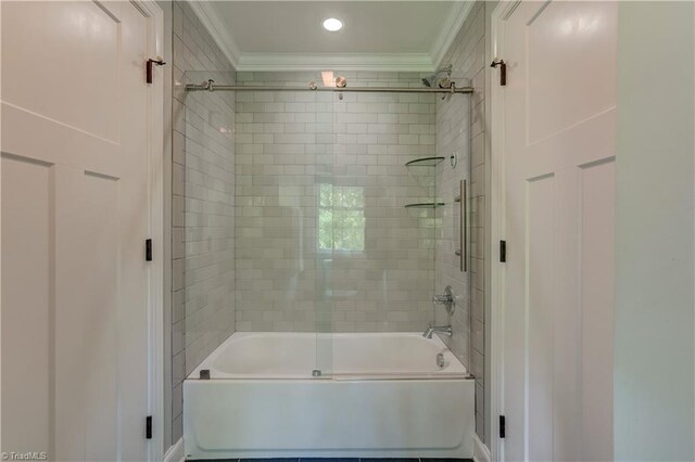 bathroom featuring crown molding and washtub / shower combination