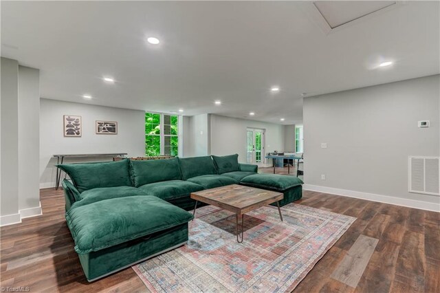 living room with wood finished floors, recessed lighting, and baseboards