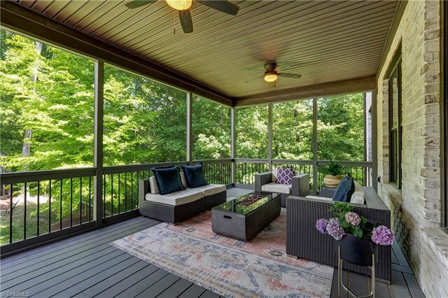 wooden terrace featuring ceiling fan and outdoor lounge area