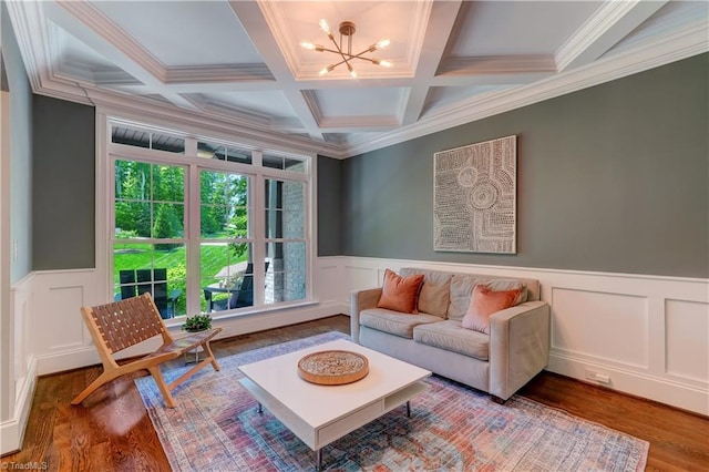 living area featuring a decorative wall, a chandelier, wainscoting, wood finished floors, and beamed ceiling
