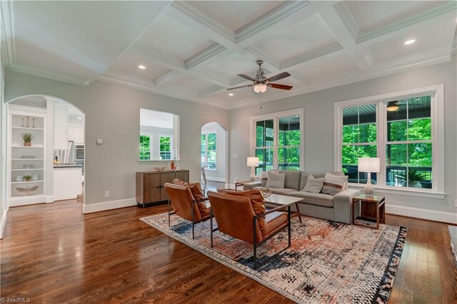 living room with arched walkways, ceiling fan, dark wood-type flooring, baseboards, and recessed lighting