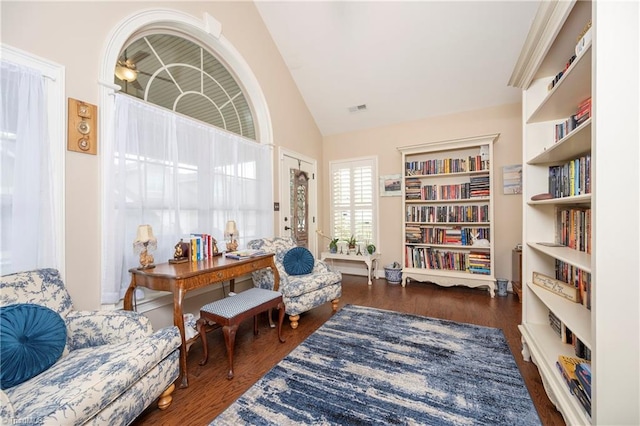 sitting room featuring dark hardwood / wood-style floors and vaulted ceiling