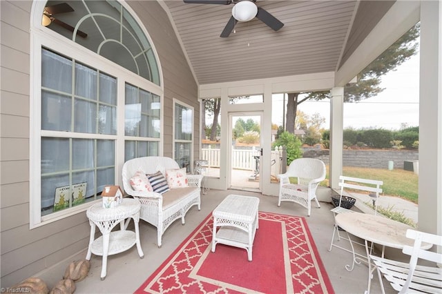 sunroom / solarium featuring ceiling fan, wood ceiling, and vaulted ceiling