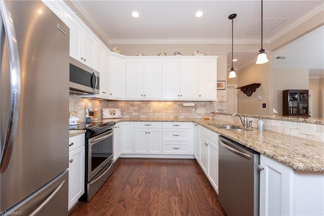 kitchen featuring sink, dark hardwood / wood-style floors, pendant lighting, appliances with stainless steel finishes, and white cabinetry