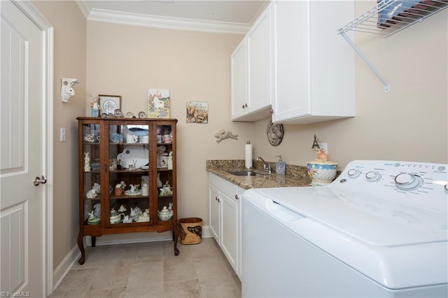 clothes washing area with cabinets, washer / dryer, sink, and crown molding