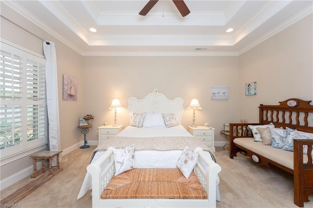 carpeted bedroom with ceiling fan, ornamental molding, and a raised ceiling